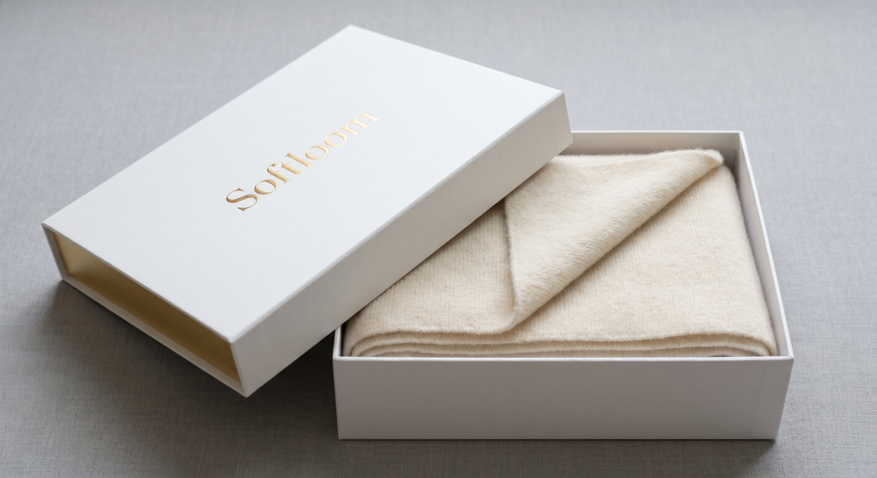 Softloom cashmere rug presented in a compact folded brand gift box